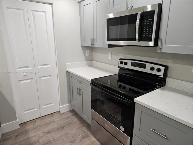 a kitchen with a stove and a microwave