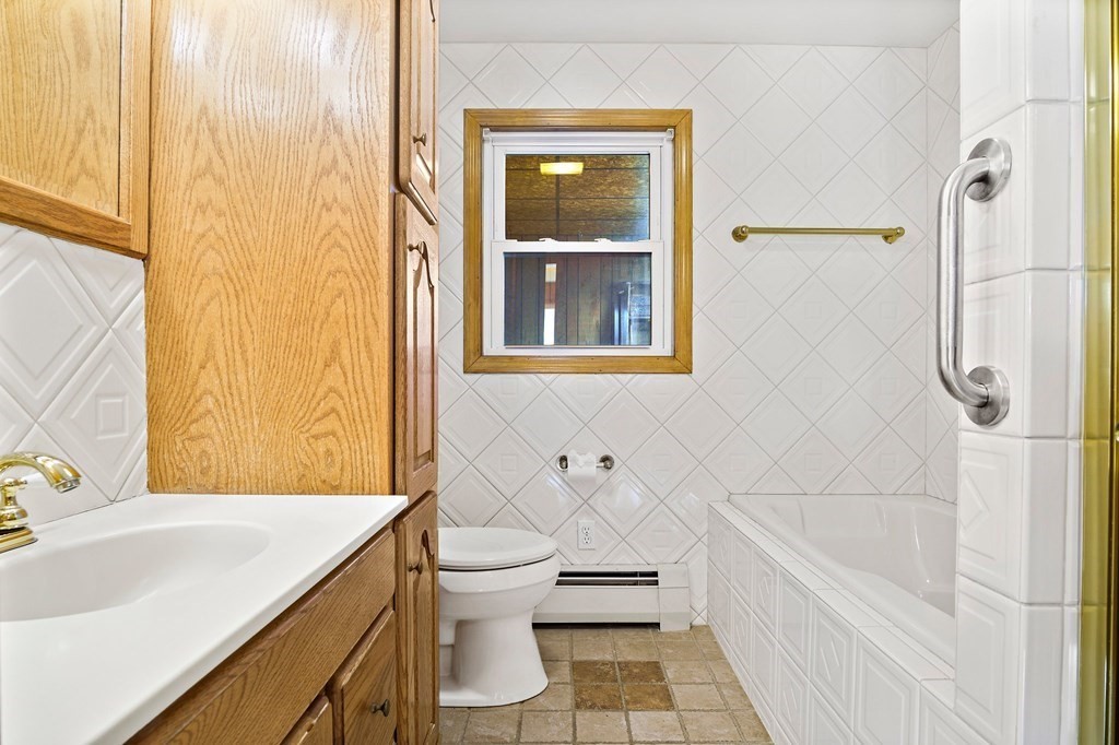 7 Roland Road Peabody, MA 01960 - Photo 12 of 24 a bathroom with a sink a toilet and shower
