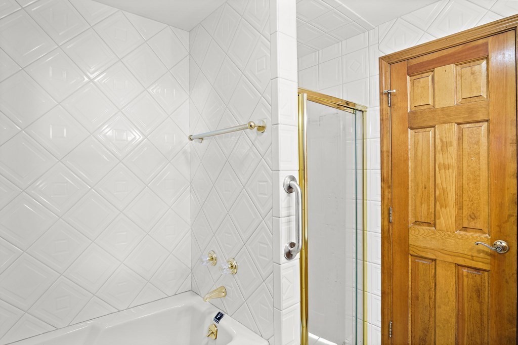 7 Roland Road Peabody, MA 01960 - Photo 14 of 24 a bathroom with a bathtub and shower