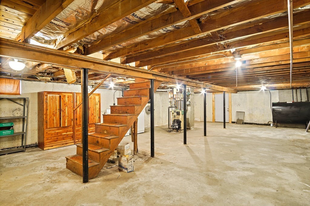 7 Roland Road Peabody, MA 01960 - Photo 19 of 24 a view of a garage with wooden table and chairs