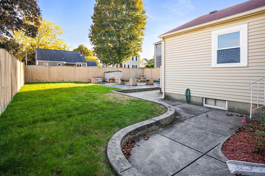 7 Roland Road Peabody, MA 01960 - Photo 23 of 24 a view of a backyard with a garden and tree