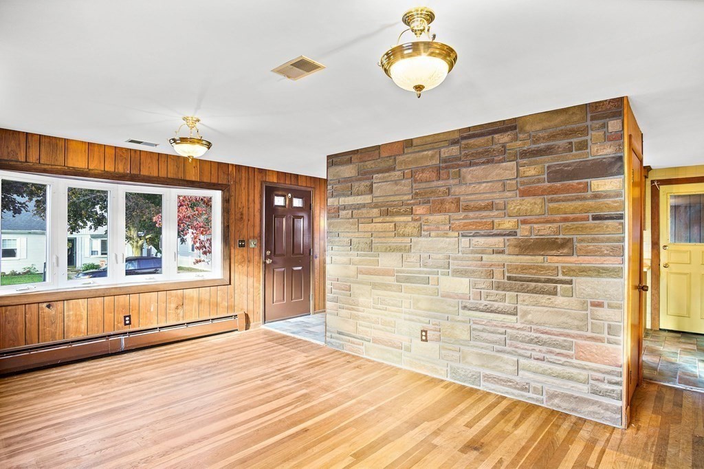 7 Roland Road Peabody, MA 01960 - Photo 3 of 24 a view of empty room with wooden floor and fan
