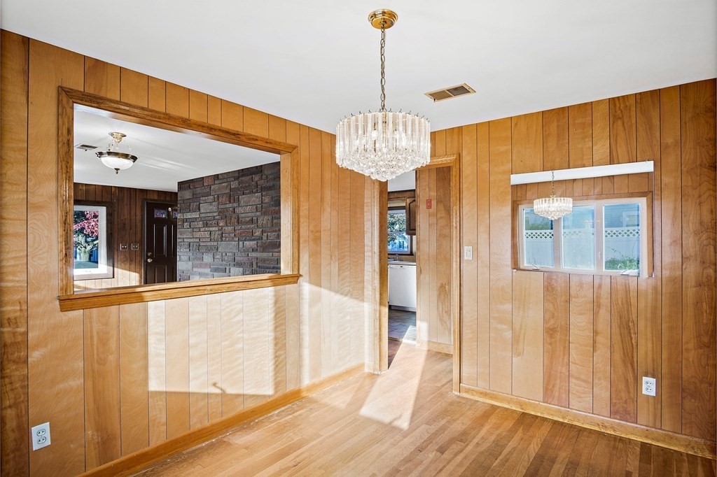 7 Roland Road Peabody, MA 01960 - Photo 6 of 24 a view of a hallway with a chandelier wooden floor and windows