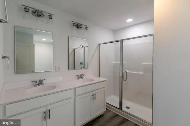 a bathroom with a shower sink and mirror