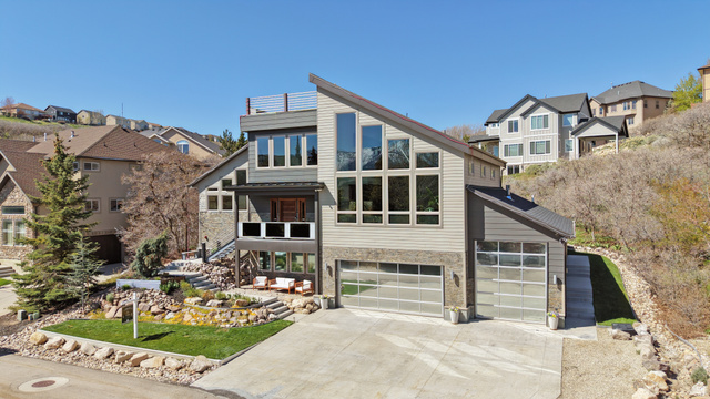 14902 Saddle Leaf Court Draper, UT 84020 - Photo 3 of 52 Contemporary home featuring stone siding, a residential view, driveway, and a garage