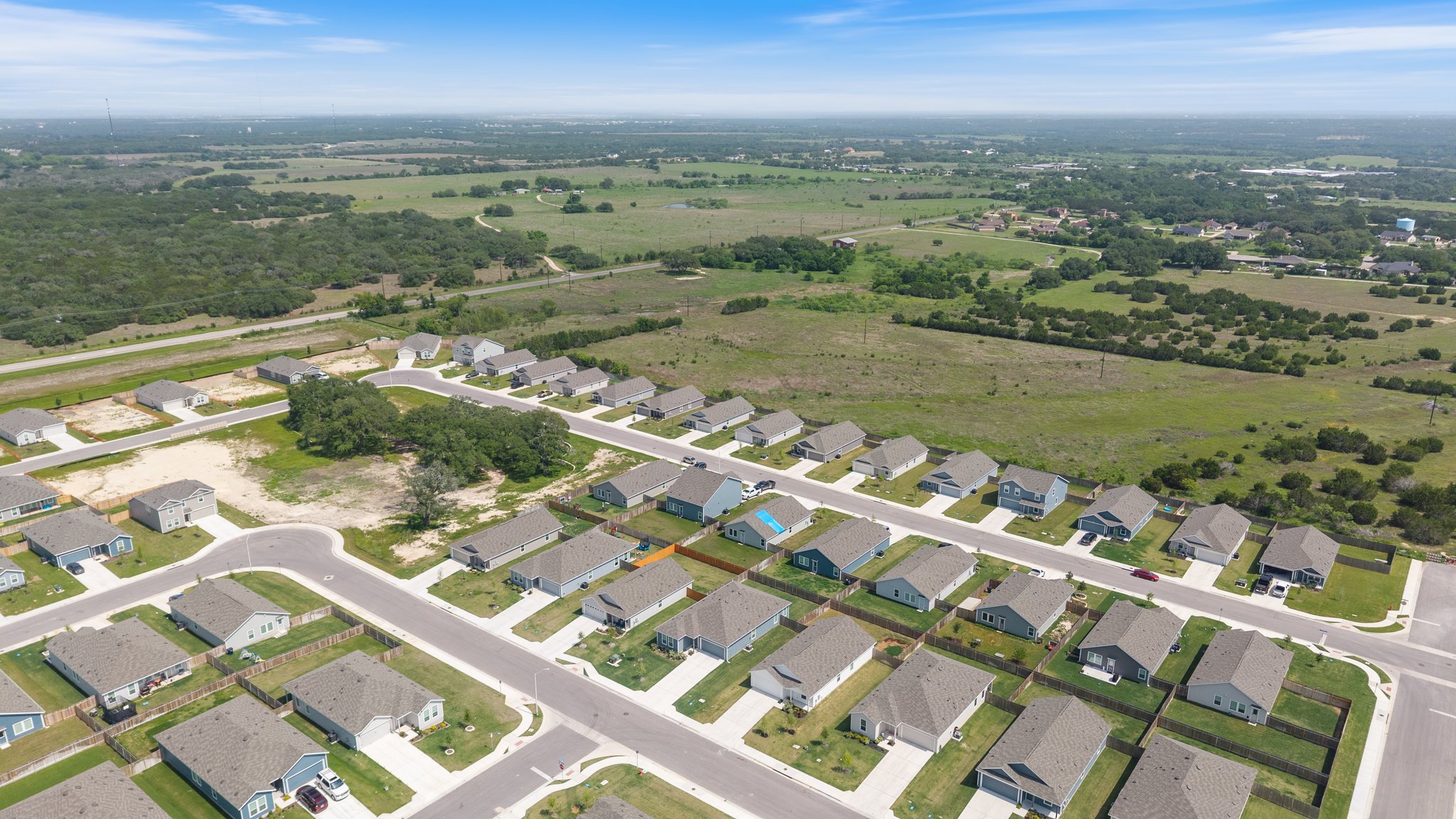 412 Heritage Grvs Road Bertram, TX 78605 - Photo 15 of 15 Aerial perspective showcasing a residential development with numerous single-story homes