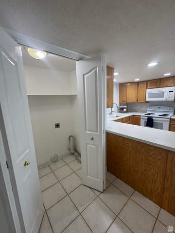 1976 River Bottom Road Springville, UT 84663 - Photo 34 of 45 Utility closet featuring white bifold doors, an overhead light fixture, and tile flooring