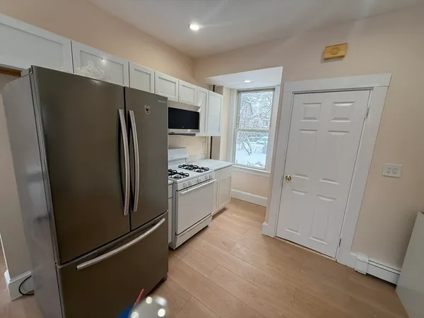 a kitchen with a refrigerator a sink and cabinets