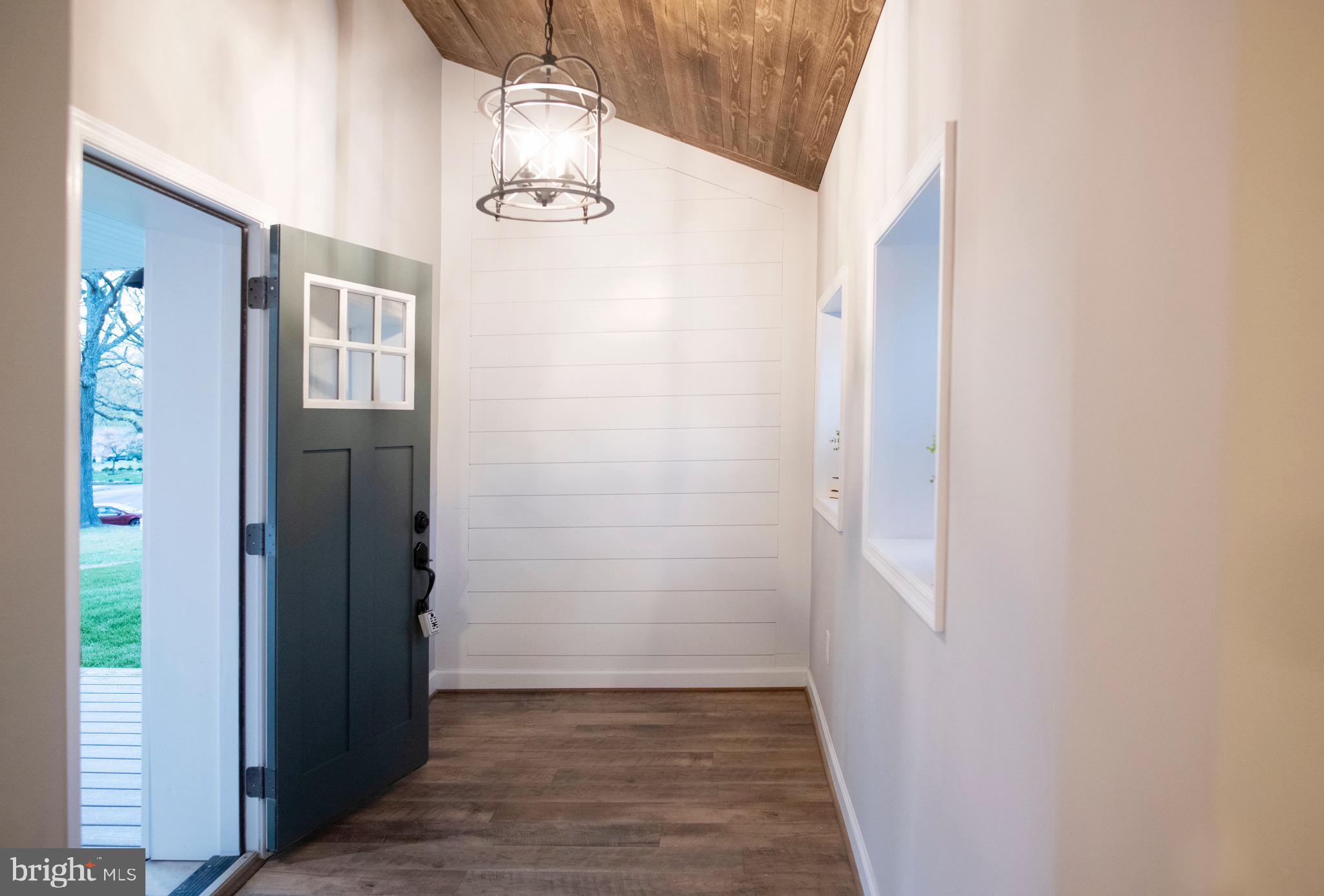 211 Sillery Bay Road Pasadena, MD 21122 - Photo 6 of 46 Foyer w/ chandelier & shiplap wall & wood ceiling