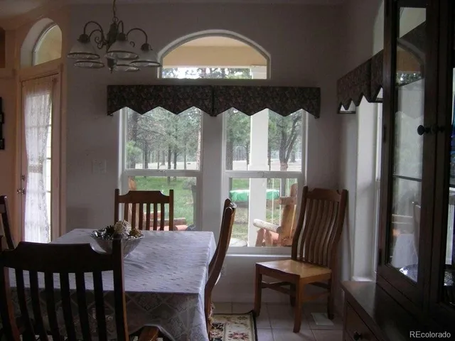 a living room with furniture and a lamp