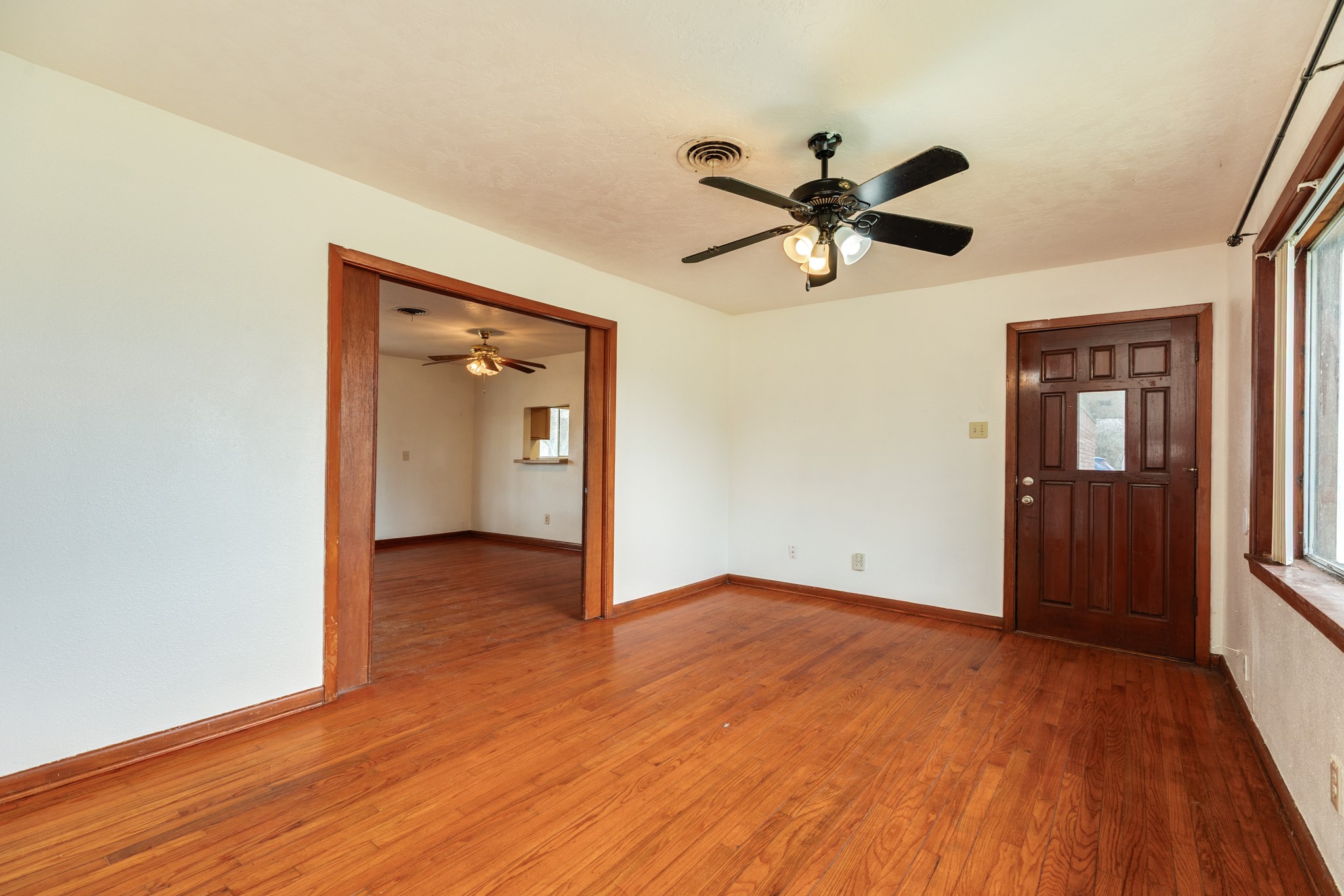 3702 Cedar Rapids Parkway Iowa Colony, TX 77583 - Photo 17 of 31 a view of an empty room and window a ceiling fan and wooden floor