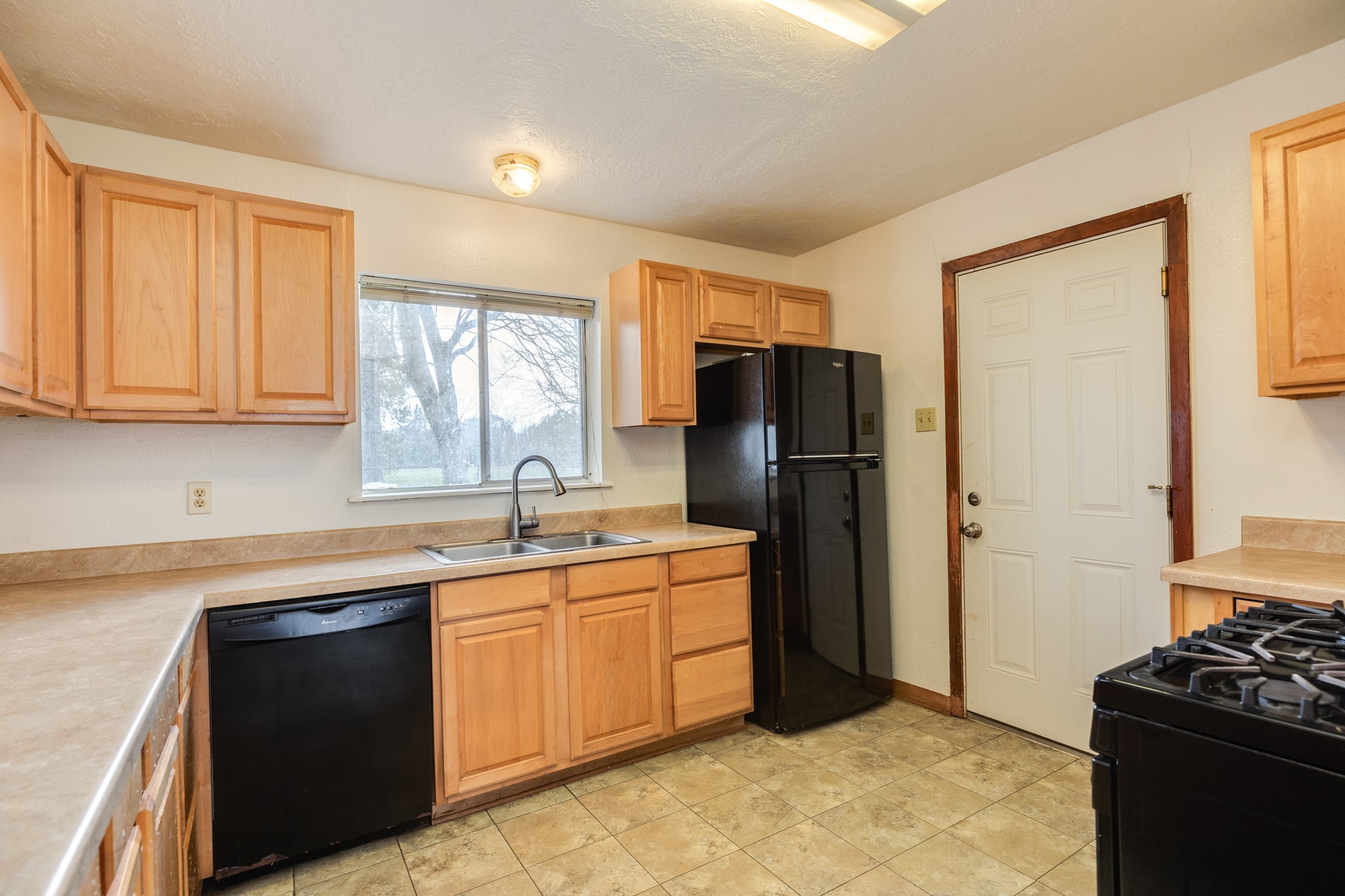 3702 Cedar Rapids Parkway Iowa Colony, TX 77583 - Photo 5 of 31 a kitchen with a refrigerator and a sink