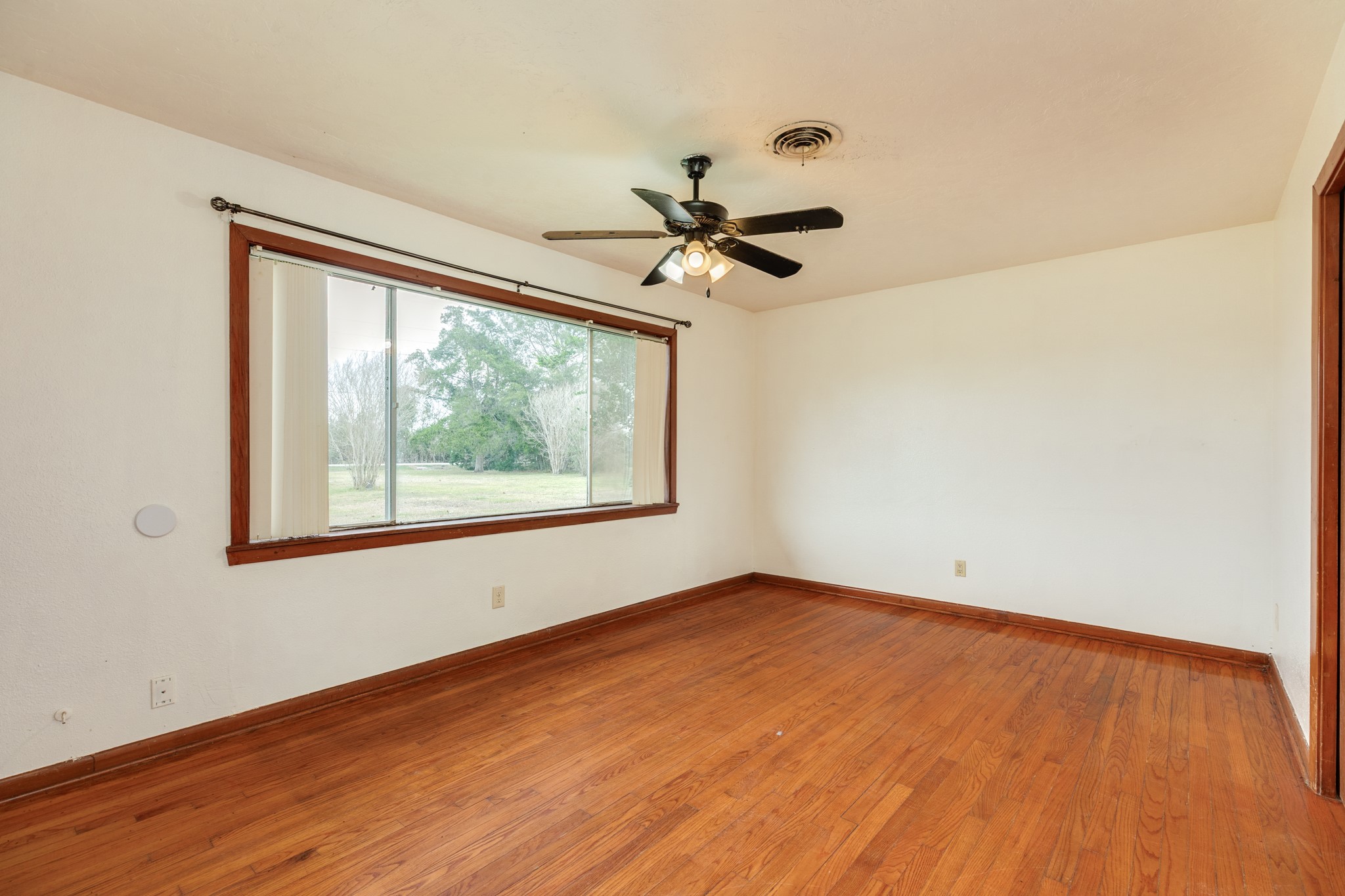 3702 Cedar Rapids Parkway Iowa Colony, TX 77583 - Photo 9 of 31 wooden floor in an empty room with a window