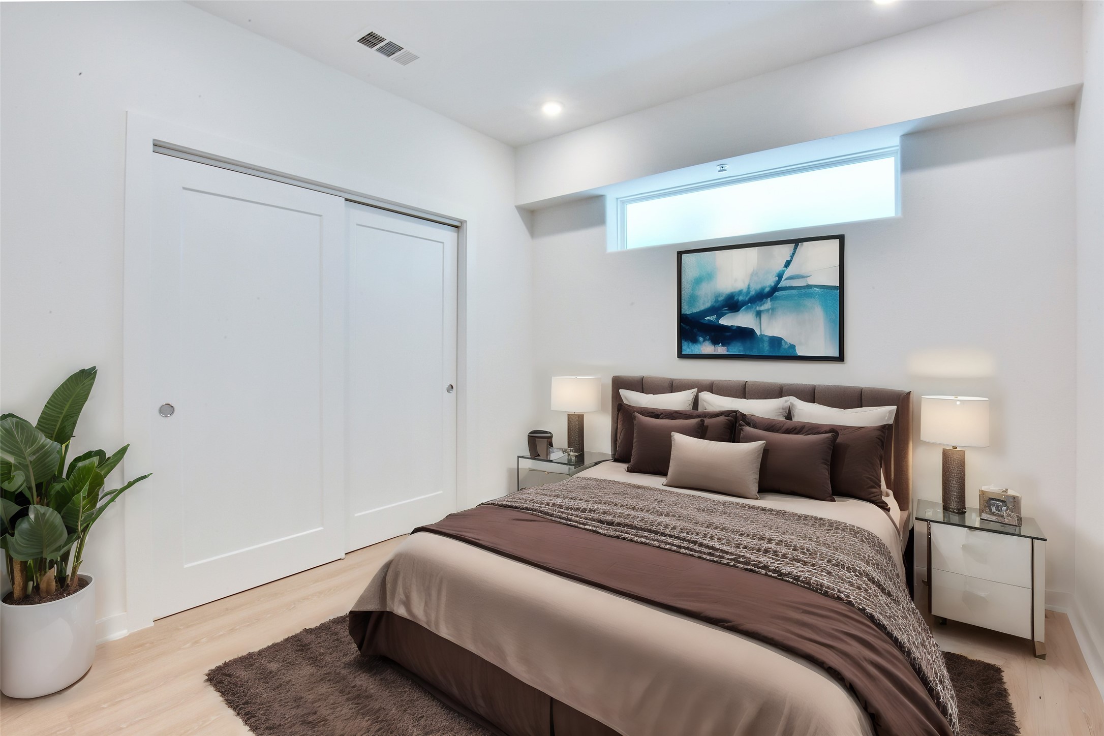 4802 South Congress Avenue, Unit 407 Austin, TX 78745 - Photo 2 of 25 a bedroom with a large bed and a potted plant