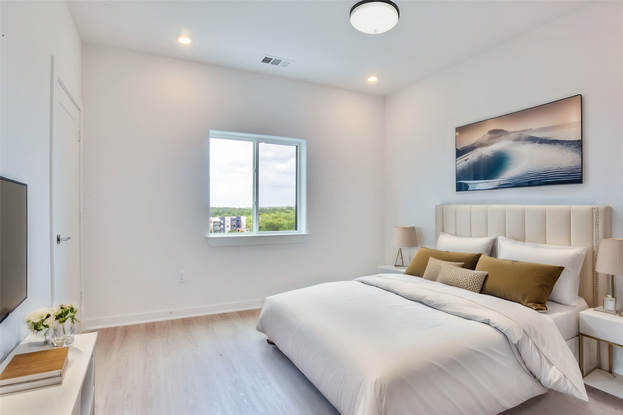 4802 South Congress Avenue, Unit 407 Austin, TX 78745 - Photo 3 of 25 a bedroom with a bed and a flat screen tv