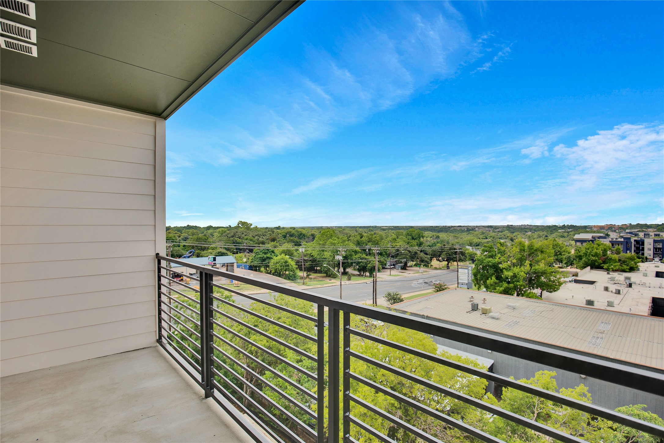 4802 South Congress Avenue, Unit 407 Austin, TX 78745 - Photo 8 of 25 a view of a balcony with wooden floor and city view