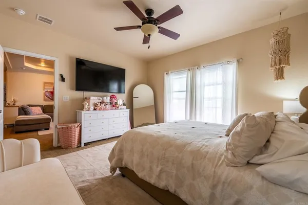 a bedroom with a large bed and a flat screen tv
