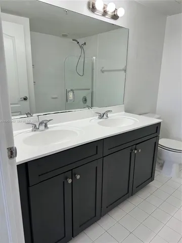 a bathroom with a sink vanity and a mirror