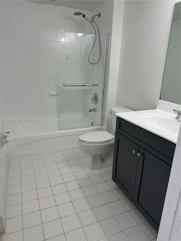 a bathroom with a granite countertop sink a toilet and a mirror