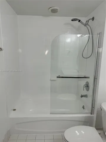 a bathroom with a shower and a toilet