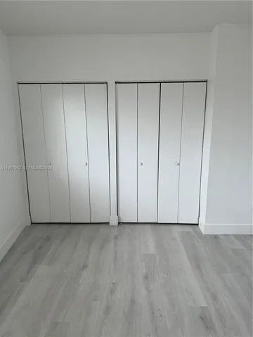 a view of room with hardwood floor