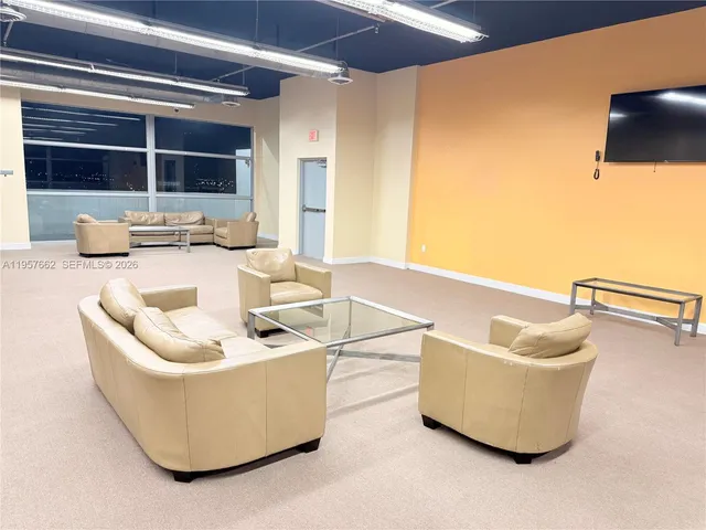 a living room with couches and a flat screen tv