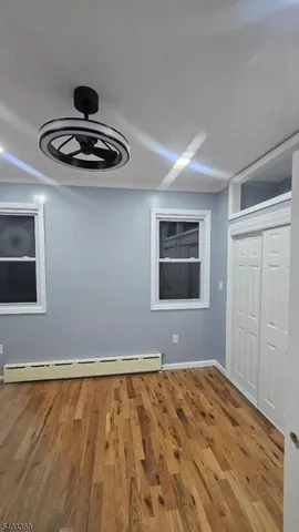 a view of wooden floor and kitchen