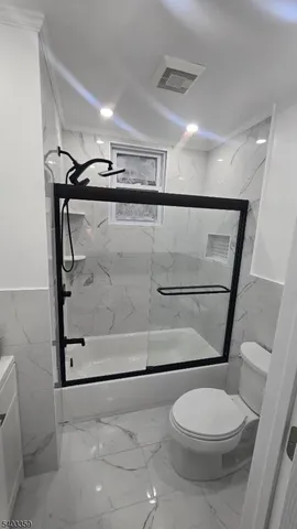 a bathroom with a toilet a sink and shower