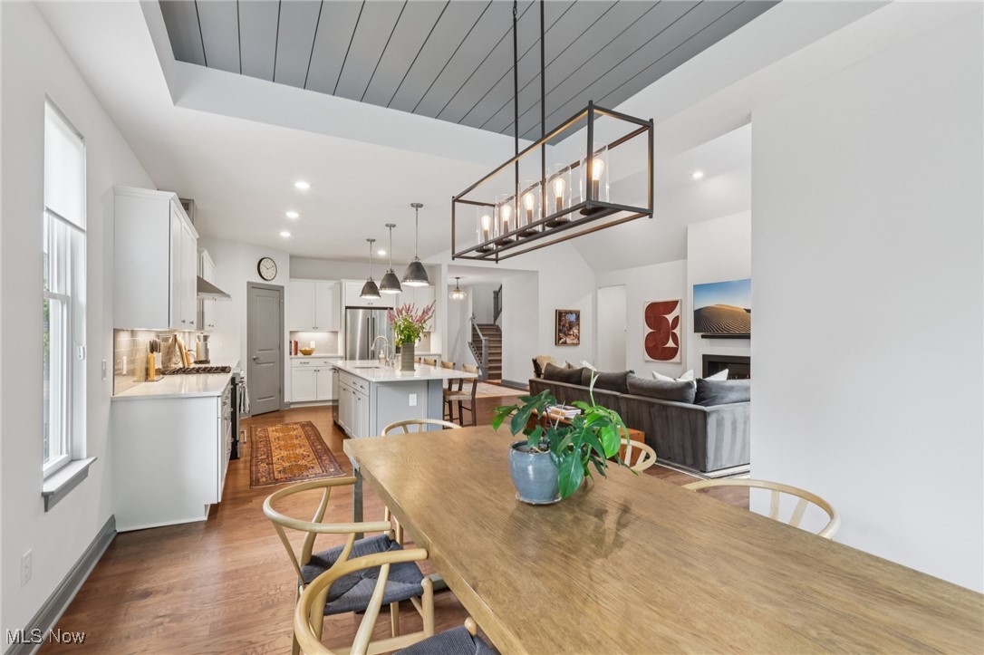 Dining area with shiplap ceiling and engineered wood floors
