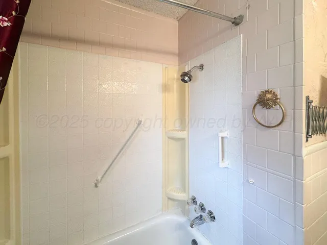 a bathroom with a shower and mirror
