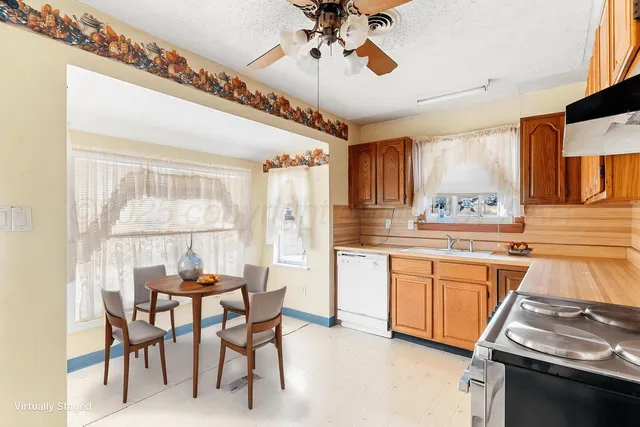 a kitchen with stainless steel appliances granite countertop a stove and a refrigerator
