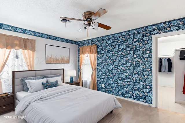 a bedroom with a bed and a window