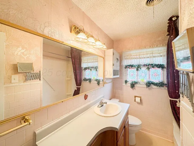a bathroom with a sink a mirror and a shower