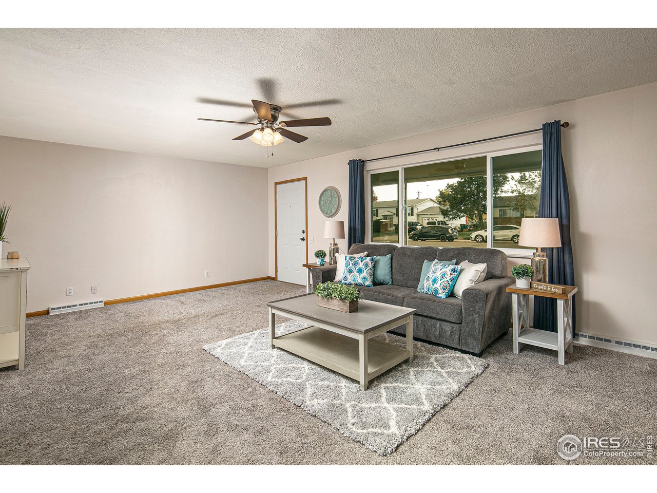 3415 West 5th St Road Greeley, CO 80634 - Photo 6 of 27 a living room with furniture a ceiling fan and a window