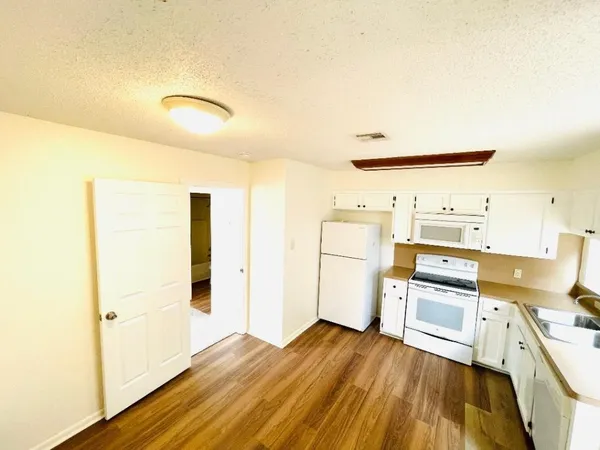 a kitchen with a refrigerator and a stove