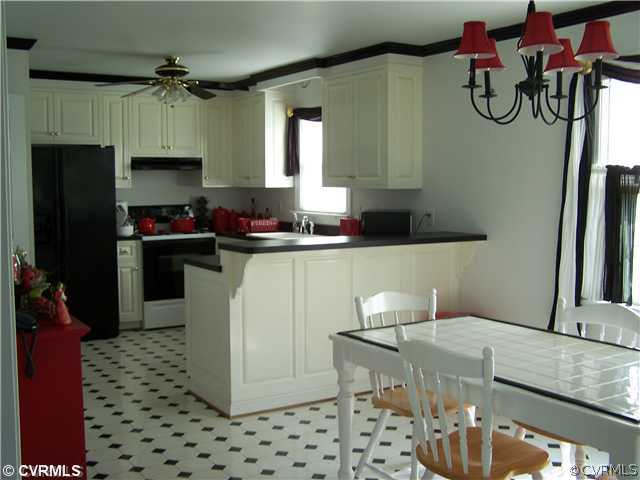 17363 Parsons Ridge Road Beaverdam, VA 23015 - Photo 2 of 12 a kitchen with stainless steel appliances granite countertop a sink a stove and a refrigerator
