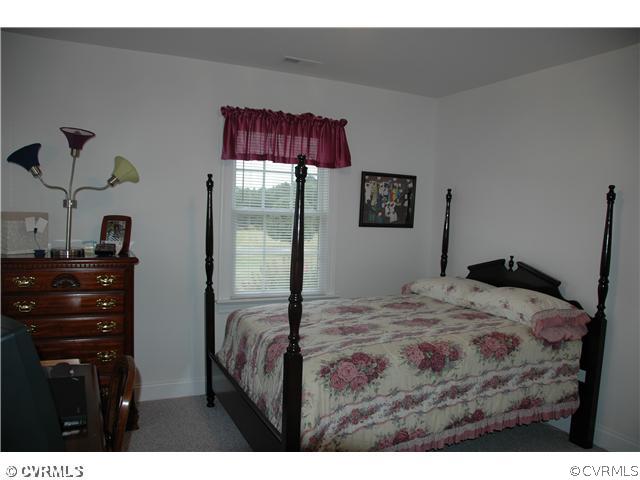 17363 Parsons Ridge Road Beaverdam, VA 23015 - Photo 8 of 12 a bedroom with a bed and a dresser