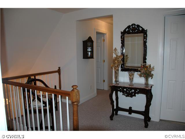 17363 Parsons Ridge Road Beaverdam, VA 23015 - Photo 9 of 12 a view of a hallway with wooden floor and furniture