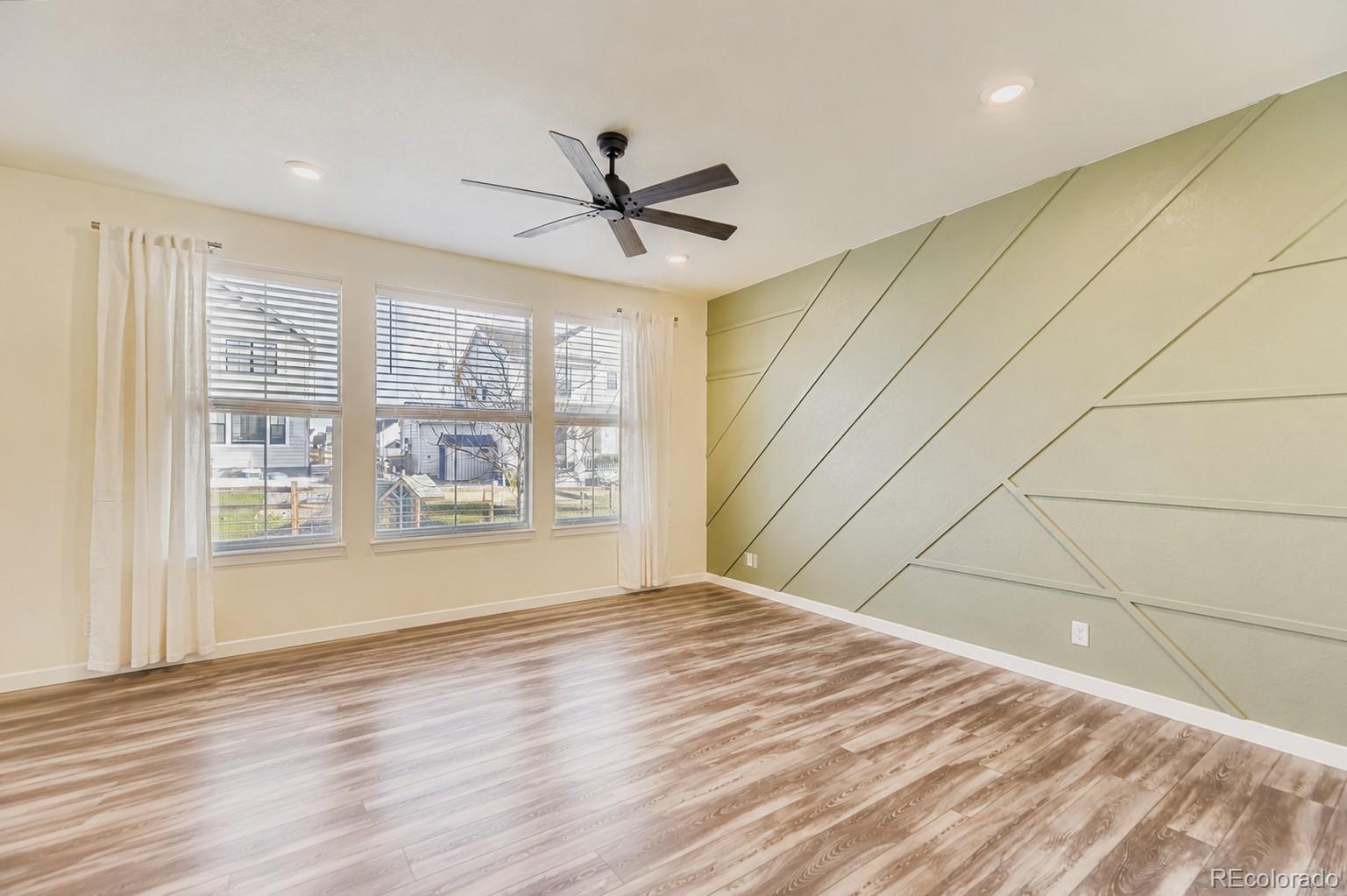 1173 Williams Loop Elizabeth, CO 80107 - Photo 5 of 30 a view of empty room with wooden floor and fan