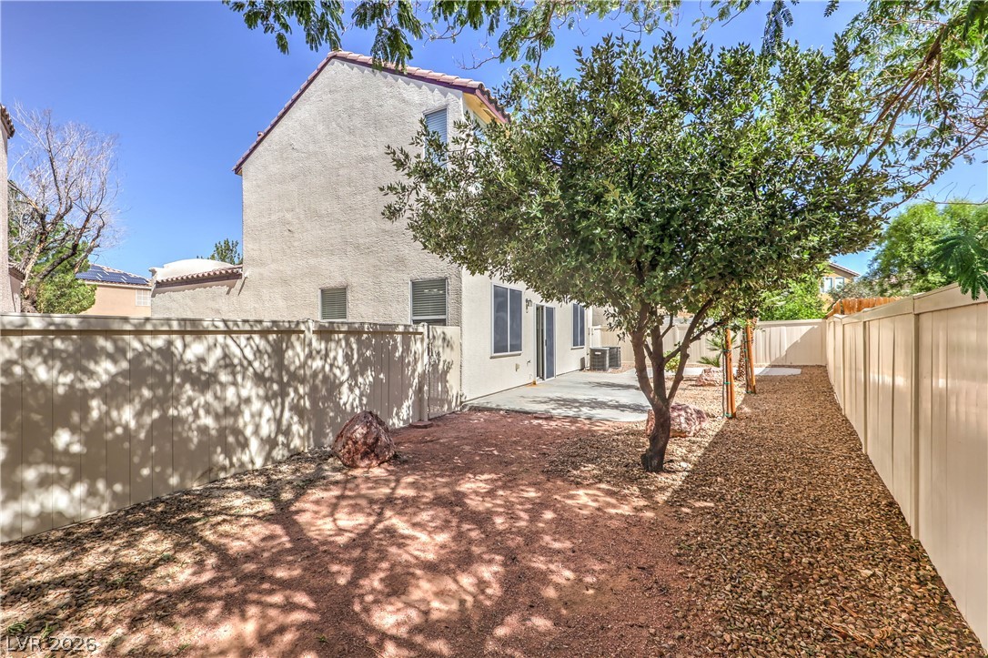 10939 Paradise Road Henderson, NV 89052 - Photo 35 of 36 A well-maintained side yard features a fenced perimeter and a mix of crushed rock and bare earth landscaping.