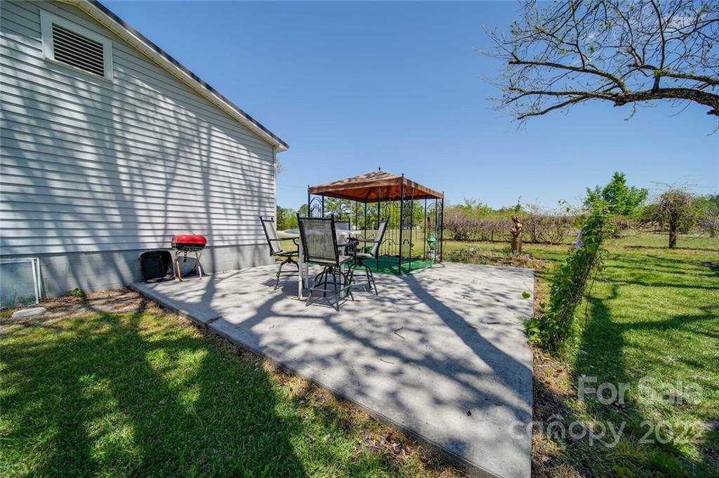 2081 Conservancy Road Kershaw, SC 29067 - Photo 12 of 46 a backyard of a house with table and chairs