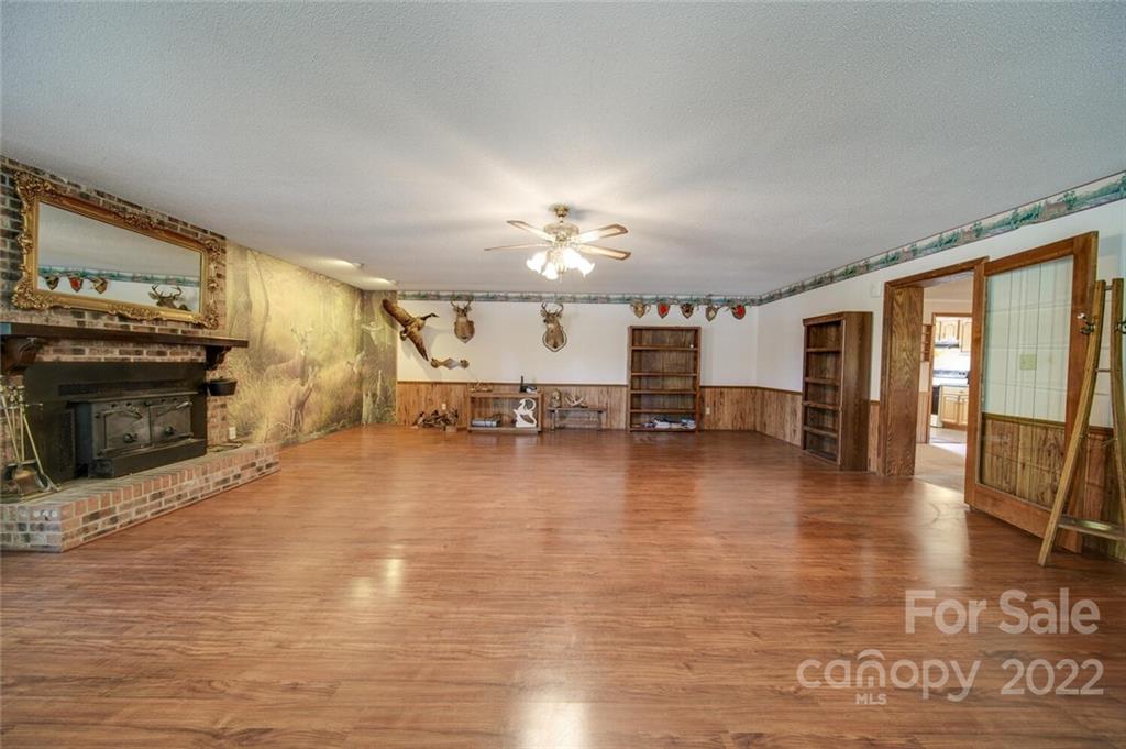 2081 Conservancy Road Kershaw, SC 29067 - Photo 13 of 46 a view of a kitchen with furniture and a fireplace
