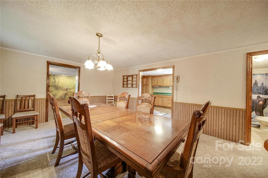2081 Conservancy Road Kershaw, SC 29067 - Photo 19 of 46 a dining room with furniture a chandelier and wooden floor