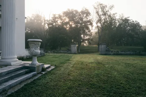 a front view of a house with garden