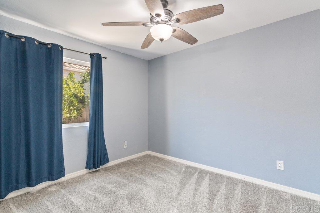 32467 Cervin Circle Temecula, CA 92592 - Photo 15 of 36 a view of a bedroom with a window and a fan