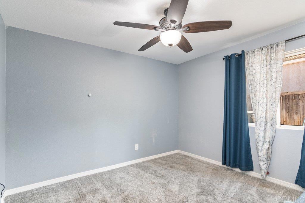 32467 Cervin Circle Temecula, CA 92592 - Photo 17 of 36 an empty room with windows and fan