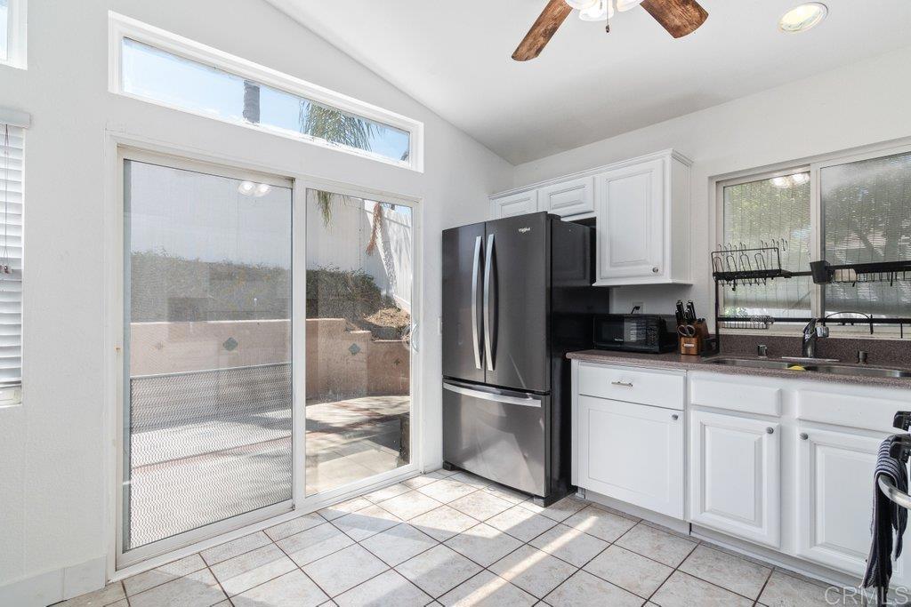 32467 Cervin Circle Temecula, CA 92592 - Photo 5 of 36 a kitchen with white cabinets and refrigerator