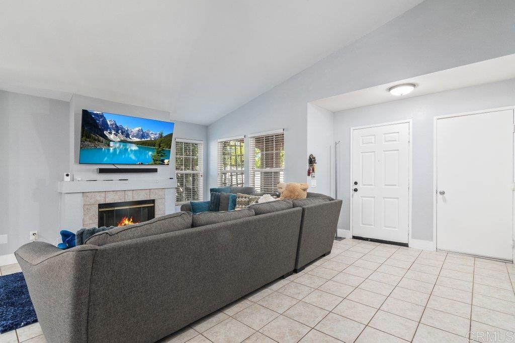 32467 Cervin Circle Temecula, CA 92592 - Photo 9 of 36 a living room with furniture a fireplace and a flat screen tv