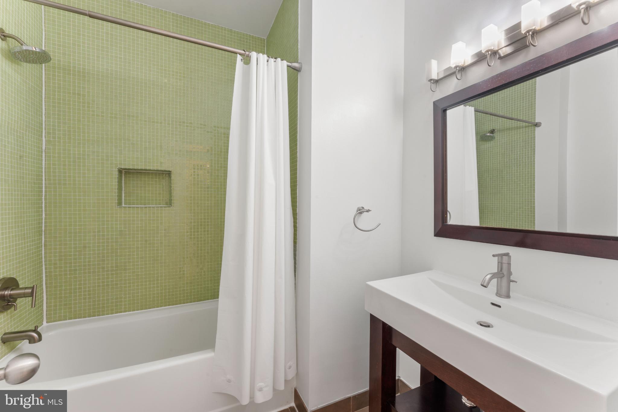333 Green Street, Unit 7 Philadelphia, PA 19123 - Photo 24 of 40 Modern bathroom with vibrant green tiles.