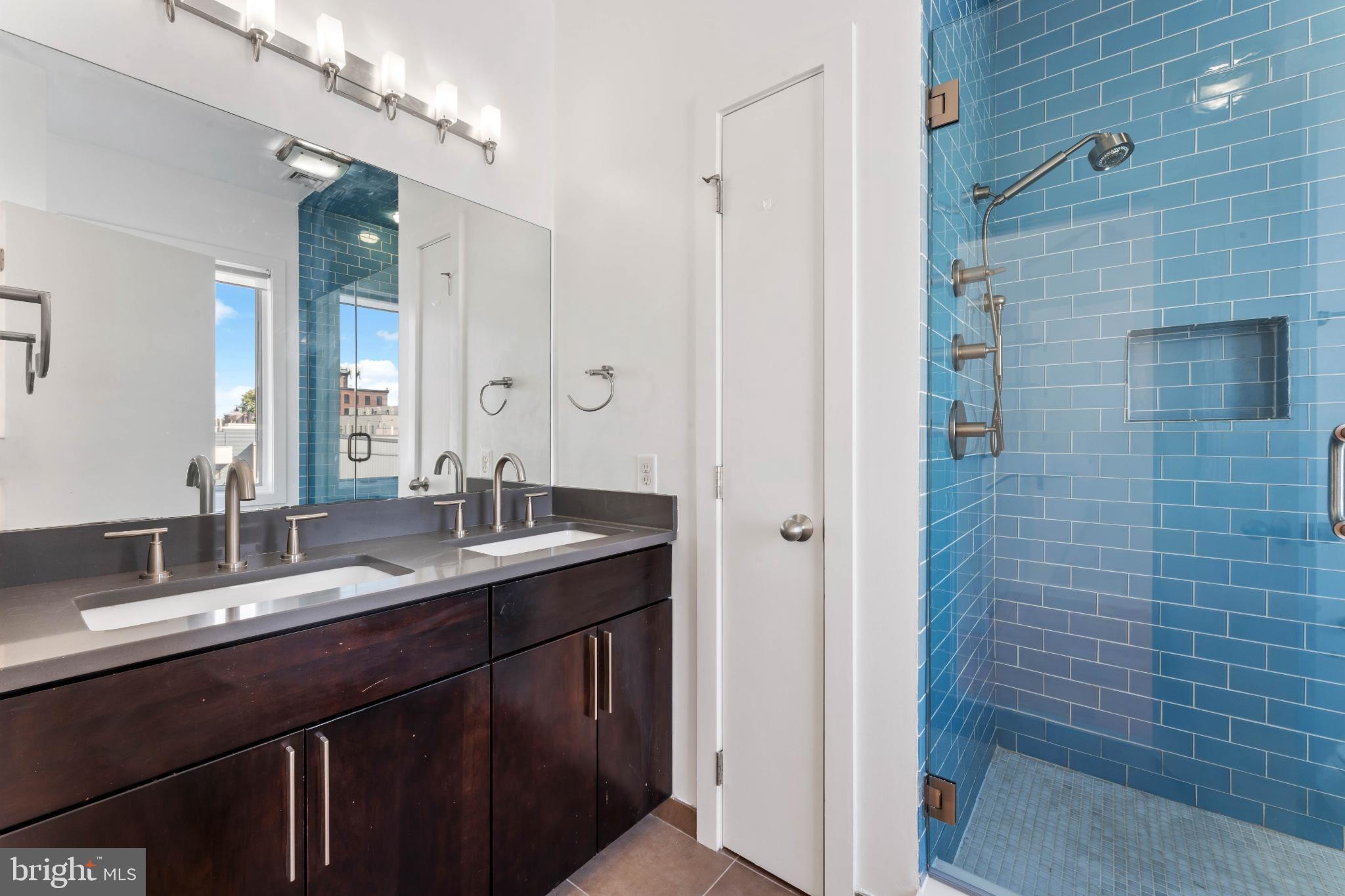333 Green Street, Unit 7 Philadelphia, PA 19123 - Photo 29 of 40 Sleek modern bathroom with vibrant tiles.